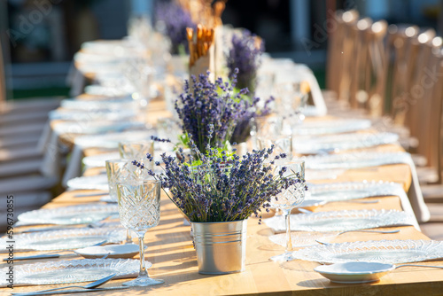 Beautiful outdoor celebration table green background with lavender decoration