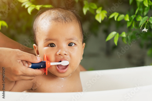 happy Asian Infant to brush teeth with mom. health care and cleaning teeth concept