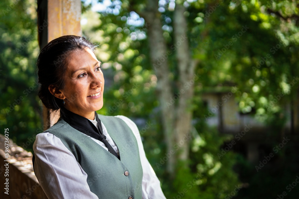 Profile portrait of a Latina woman dressed in traditional clothes, in an old train station smiling Profile portrait of a Latina woman dressed in traditional clothes, in an old train station smiling