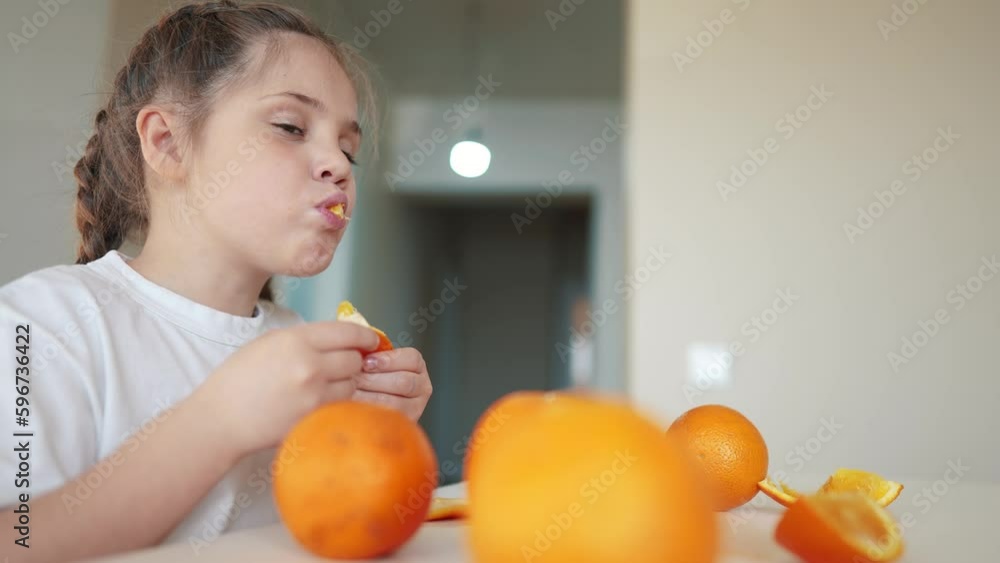 girl child eating oranges. dream happy family fruit indoors healthy