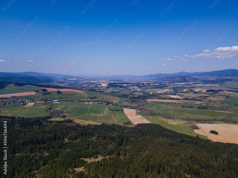 A drone view of the Orlicke hory landscape with forest and meadows.. Czech republic.