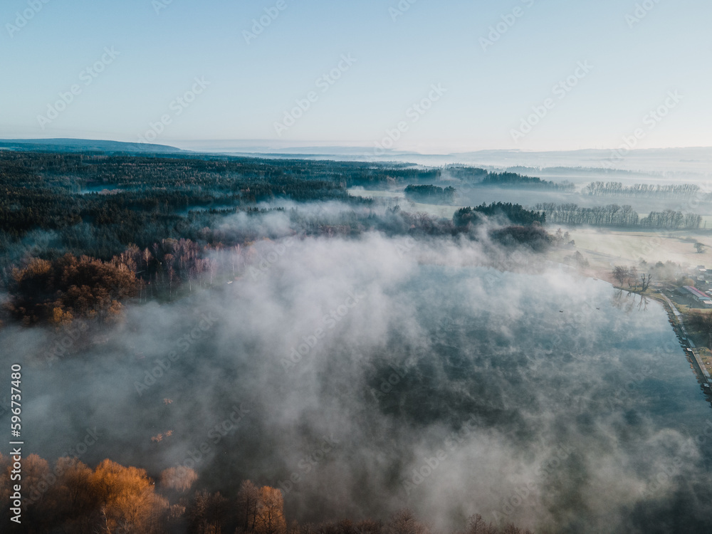 A lake covered with fogg during spring morning. Svitavy, Czech republic.