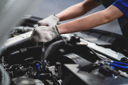Car care and maintenance, hands-on car mechanic using a wrench to fix the car engine problem. Audit and Service Concepts