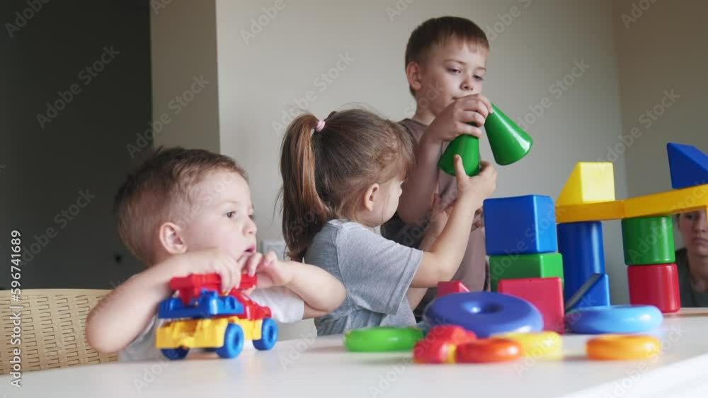 kindergarten. a group of children play toys cubes and cars on the table in kindergarten. kid dream indoor creative happy family preschool education concept. nursery baby toddler home kindergarten. a group of children play toys cubes and cars on the table in kindergarten. kid dream indoor creative happy family preschool education concept. nursery baby toddler home