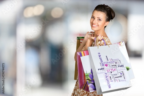 Happy young woman holds shopping bags