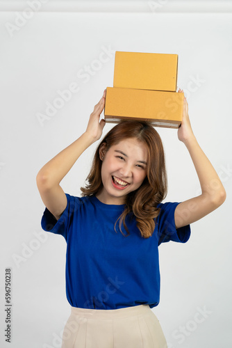 Happy asian woman holding parcel boxes doing various gestures isolated on white background Delivery and courier service concept