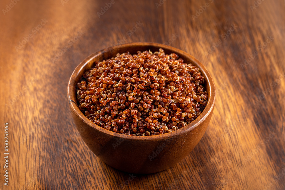 Cooked red quinoa bowl. 45 degrees studio shoot on wooden background. Cooked red quinoa bowl. 45 degrees studio shoot on wooden background.