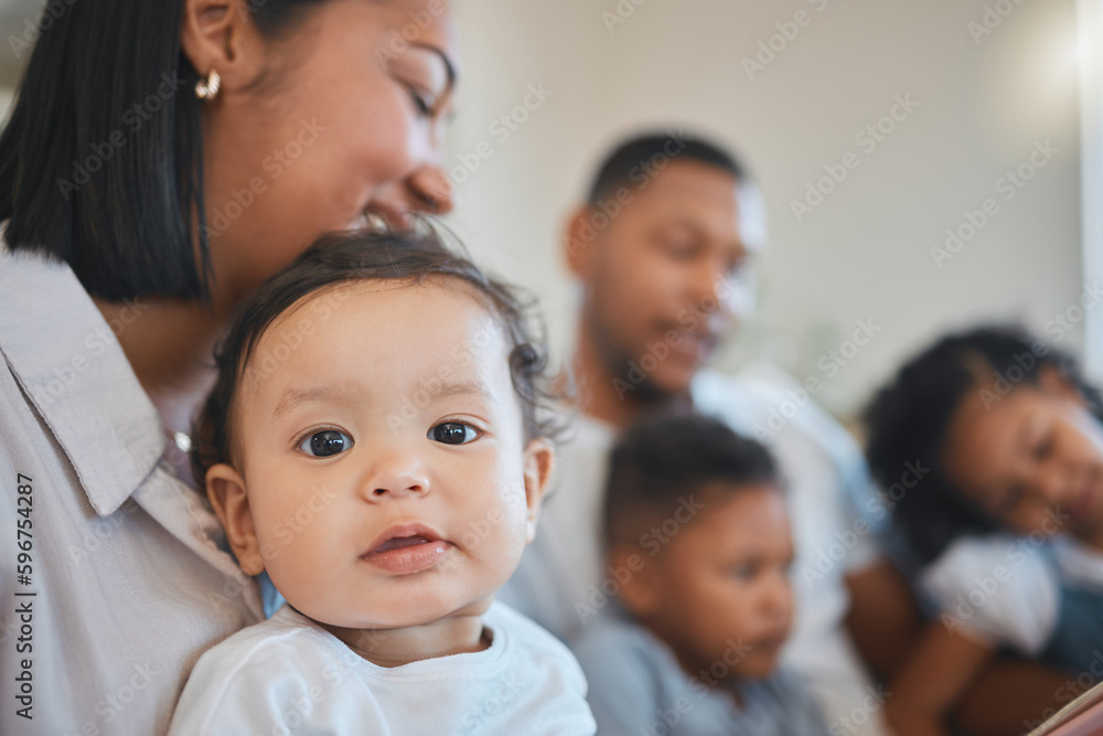 Whos the cutest you guessed it. Shot of a young family happily bonding together on the sofa at home. Whos the cutest you guessed it. Shot of a young family happily bonding together on the sofa at home.