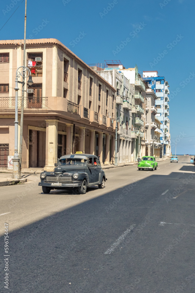 Old American car in Galiano street Havana Cuba with old buildings