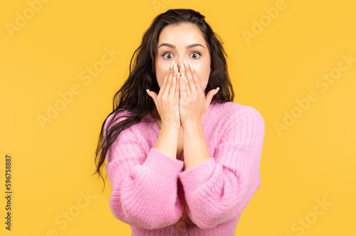 Shocked scared happy millennial arab lady in casual, covering mouth with hands