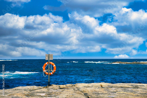 Lifebuoy on a rock by the sea. William Bay National Park, Western Australia. 