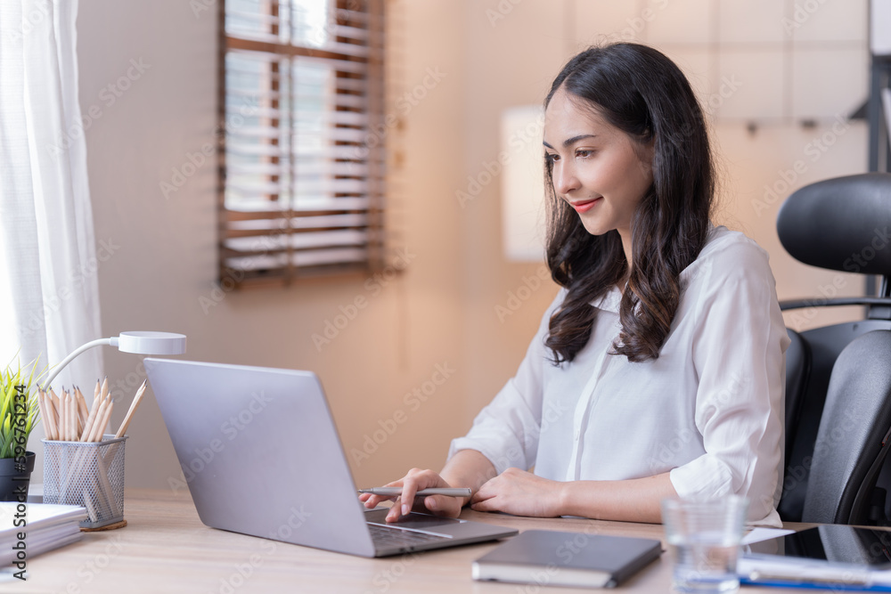 Young happy businesswoman working with tablet and mobile phone in corporate office. Young happy businesswoman working with tablet and mobile phone in corporate office.
