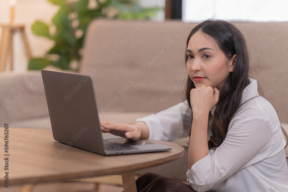 Full length photo of positive student girl sit floor legs crossed folded work remote laptop read document report hold mug beverage in house indoors Full length photo of positive student girl sit floor legs crossed folded work remote laptop read document report hold mug beverage in house indoors