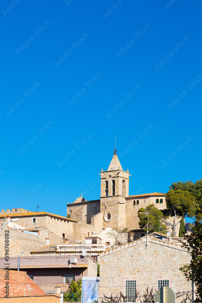 Silhouette and bell tower of the church of the village of Santa Cristina de Aro in Baix Amporda in Girona, Costa Brava, Catalonia, Spain.