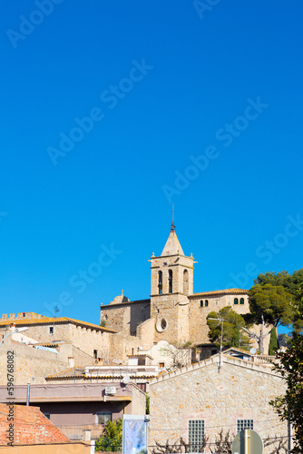 Silhouette and bell tower of the church of the village of Santa Cristina de Aro in Baix Amporda in Girona, Costa Brava, Catalonia, Spain.