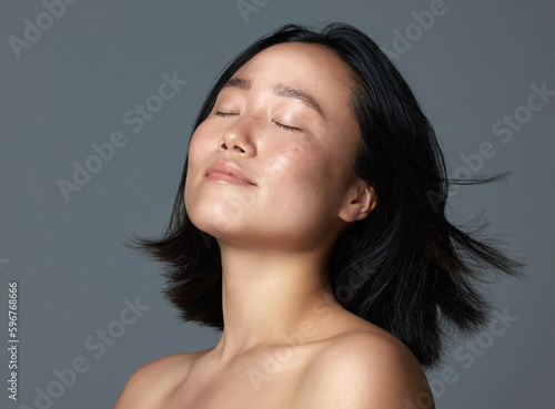 Its her glow for me. Studio shot of a beautiful young woman posing against a grey background.