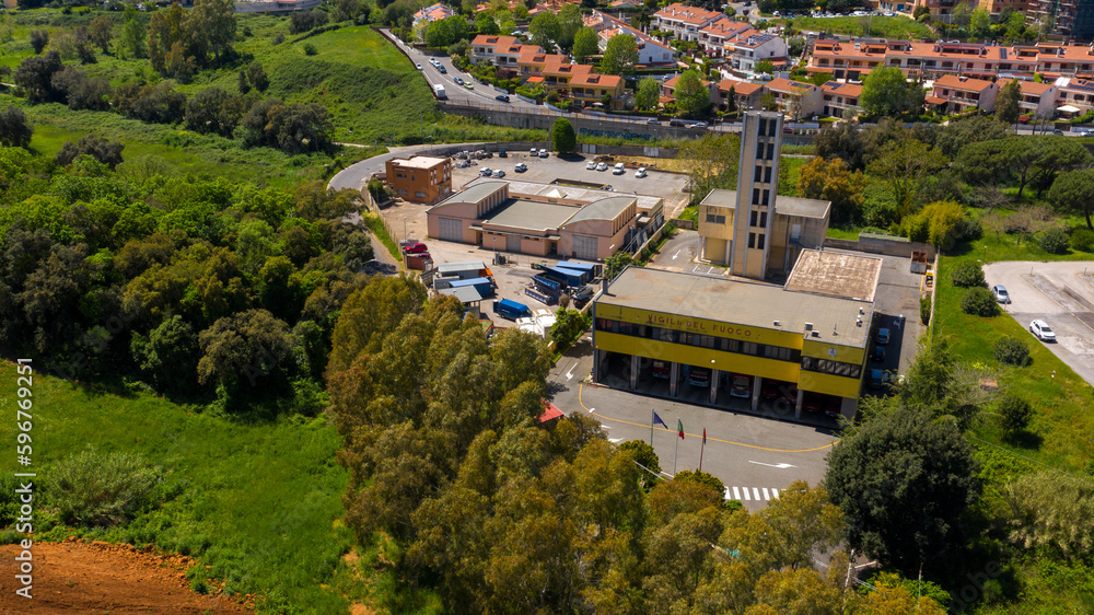 Aerial view of the fire station of Pomezia, in the metropolitan city of Rome, Italy. The trucks are inside the garages.