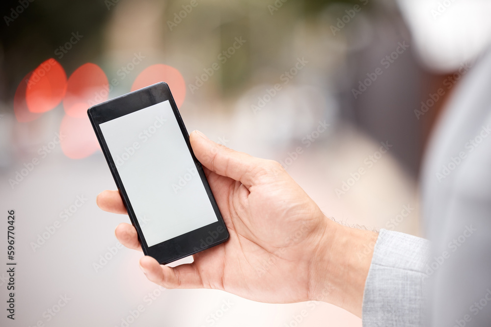 Its a new app. Shot of an unrecognizable businessperson holding a phone in the city. Its a new app. Shot of an unrecognizable businessperson holding a phone in the city.