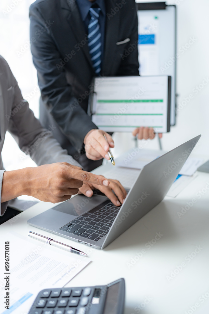 Group of businesspeople meeting together analyzing and pointing laptop about business growth. Group of businesspeople meeting together analyzing and pointing laptop about business growth.