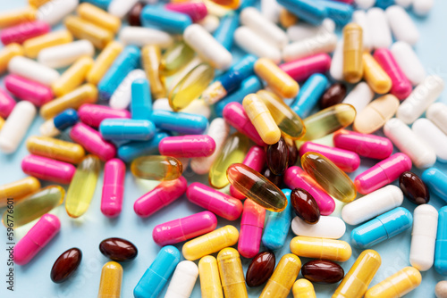 Lots of colorful pills and capsules for different symptoms. Concept of health and medicine.