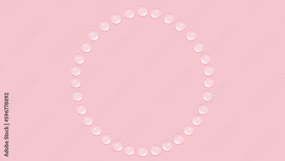 Drops of transparent gel or water are arranged in a circle. On a pink background.