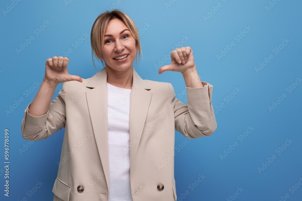 portrait of a kind pleasant young blonde business woman in a jacket on the background with copy space portrait of a kind pleasant young blonde business woman in a jacket on the background with copy space
