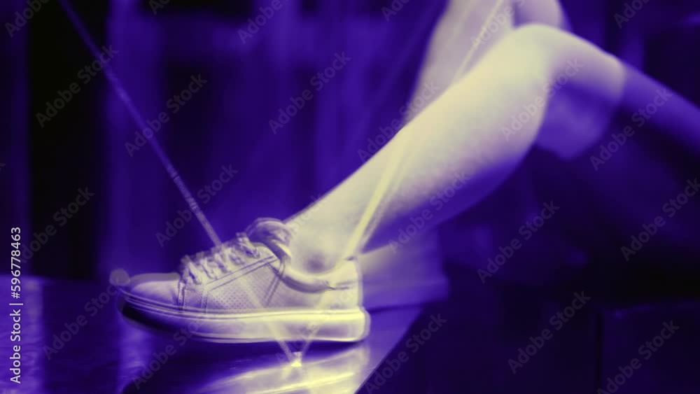sexy woman legs in white cotton stockings and sneakers in darkness with flashing laser rays sexy woman legs in white cotton stockings and sneakers in darkness with flashing laser rays
