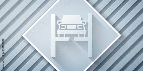 Paper cut Repair car on lift icon isolated on grey background. Repair of the underbody, suspension, wheels and engine. Paper art style. Vector