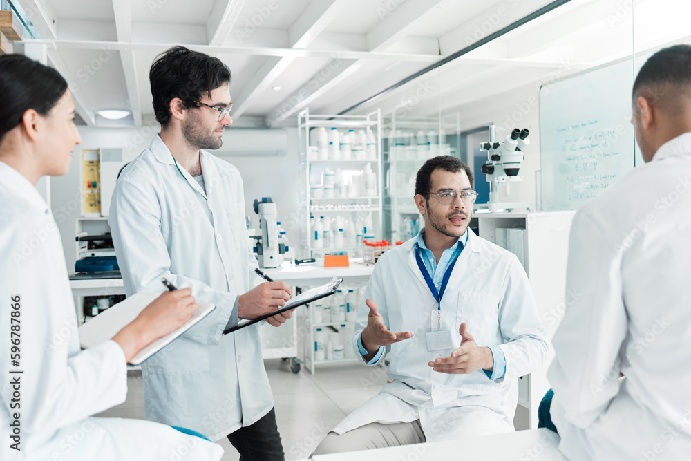 Coming together to share facts and findings. Shot of a group of scientists working together in a lab. Coming together to share facts and findings. Shot of a group of scientists working together in a lab.
