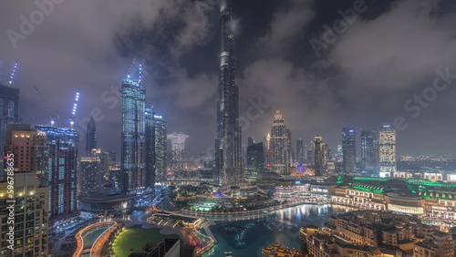 Photography Skyscrapers rising above Dubai downtown night timelapse surrounded by modern bui