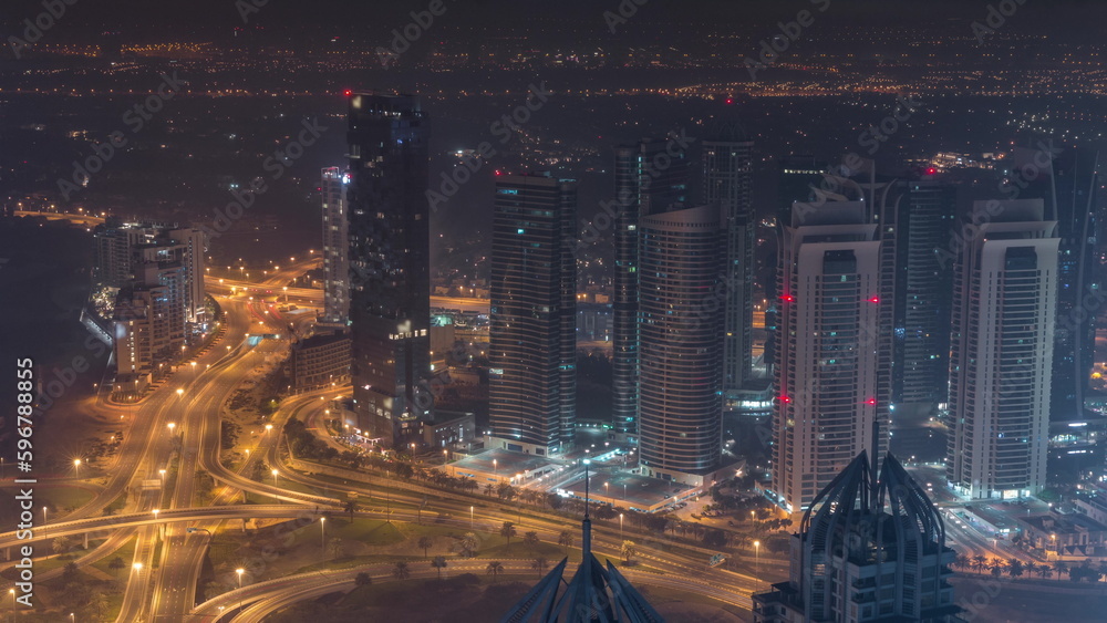 JLT and Dubai marina skyscrapers near Sheikh Zayed Road aerial all night timelapse. Residential buildings JLT and Dubai marina skyscrapers near Sheikh Zayed Road aerial all night timelapse. Residential buildings