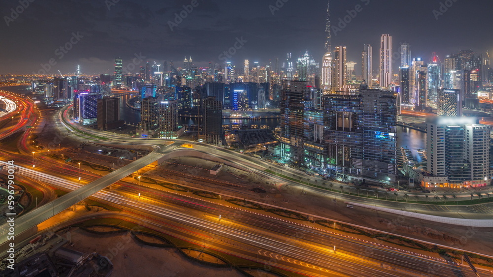 Obraz premium Skyline with modern architecture of Dubai business bay towers day to night timelapse. Aerial view