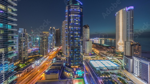 Panoramic view of the Dubai Marina and JBR area and the famous Ferris Wheel aerial day to night timelapse photo