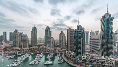 Luxury yacht bay in the city aerial night to day timelapse in Dubai marina © neiezhmakov