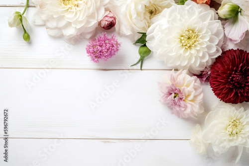 A white wood background topped with lots of beautiful white, pink and violet flowers , blank space and text space. Abstract natural floral layout with text space and copy space. Wedding invitation. In