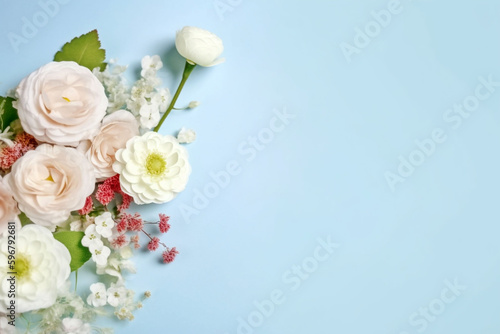 A blue background topped with beautiful flowers such as baby's breath, rose, cherry blossom and ranunculus. for banners, cards, mockups, backgrounds and template ai-generated