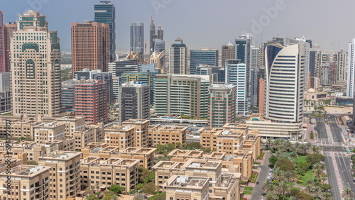 Skyscrapers in Barsha Heights district and low rise buildings in Greens district aerial all day timelapse. Dubai skyline