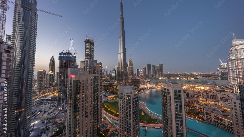 Obraz premium Panorama of Dubai Downtown cityscape with tallest skyscrapers around aerial day to night timelapse.