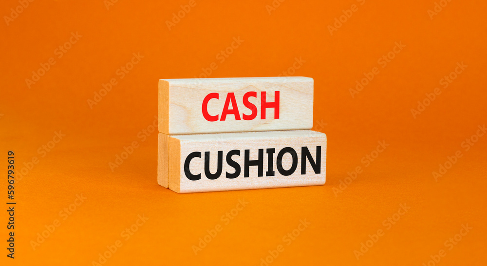 Cash cushion symbol. Concept words Cash cushion on beautiful wooden block. Beautiful orange table orange background. Business and Cash cushion concept. Copy space. Cash cushion symbol. Concept words Cash cushion on beautiful wooden block. Beautiful orange table orange background. Business and Cash cushion concept. Copy space.