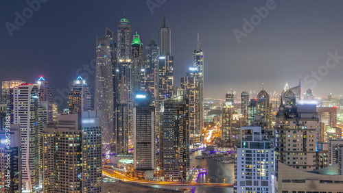 View of various skyscrapers in tallest recidential block in Dubai Marina aerial day to night timelapse © neiezhmakov