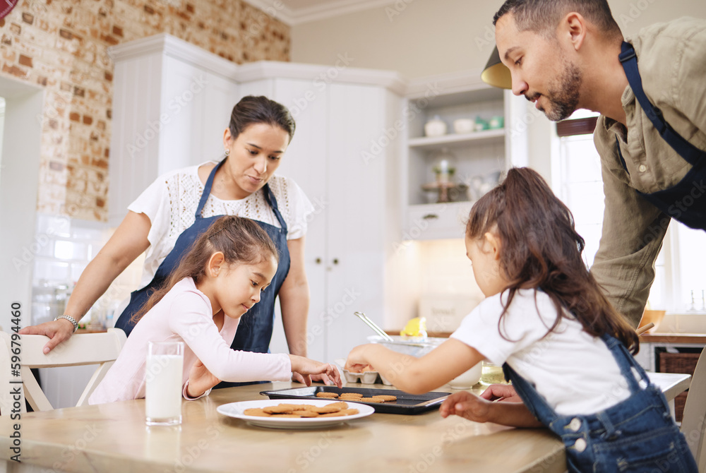 Baking is love made visible. Shot of a couple and their children baking together at home.