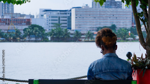 a man standing in front of a lake in abidjan