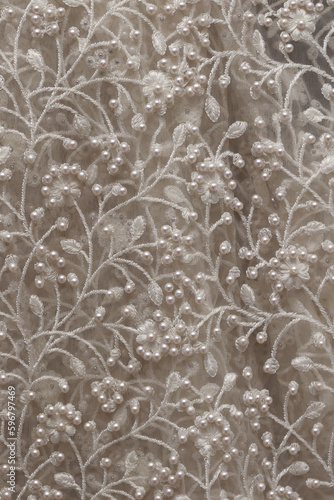 intricate design with pearls. Close up of detail on wedding gown