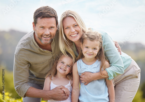 Family members can be your best friends. Shot of a couple and their two daughters posing together in a park.