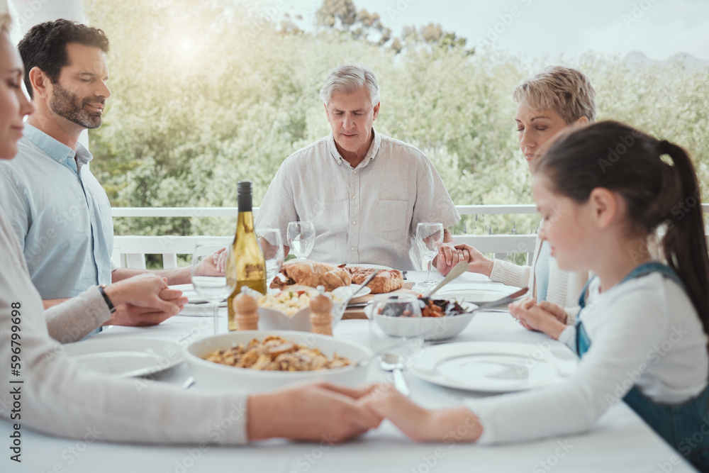 All great change begins at the dinner table. Shot of a beautiful family blessing the food with a prayer at the table together at home. All great change begins at the dinner table. Shot of a beautiful family blessing the food with a prayer at the table together at home.