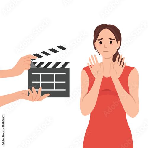 Woman movie star is embarrassed sees clapboard passing casting call for role in popular series or tv show. Movie star girl waving hands, not wanting to film or answer questions from reporters