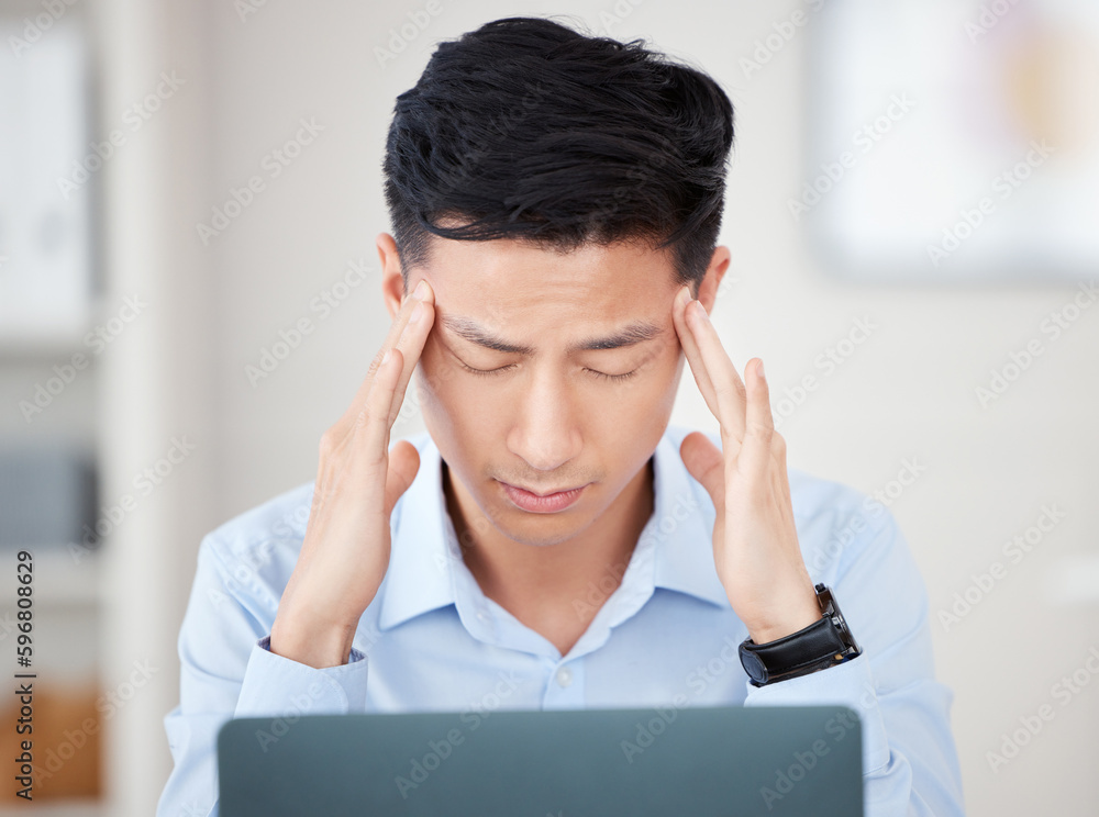 I cant deal with this right now. Shot of a young businessman suffering from a headache at work. I cant deal with this right now. Shot of a young businessman suffering from a headache at work.