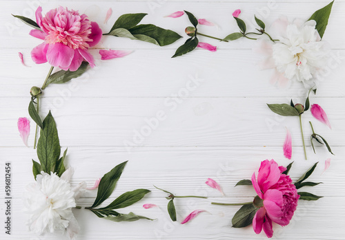 Fototapeta Naklejka Na Ścianę i Meble -  Pink and white peonies on a white wooden background, copy space, flat lay, greeting card.