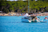 Catamaran anchored in the Mediterranean Sea in front of the beach of Cala Agulla on the eastern coast of Mallorca in the Balearic Islands, Spain