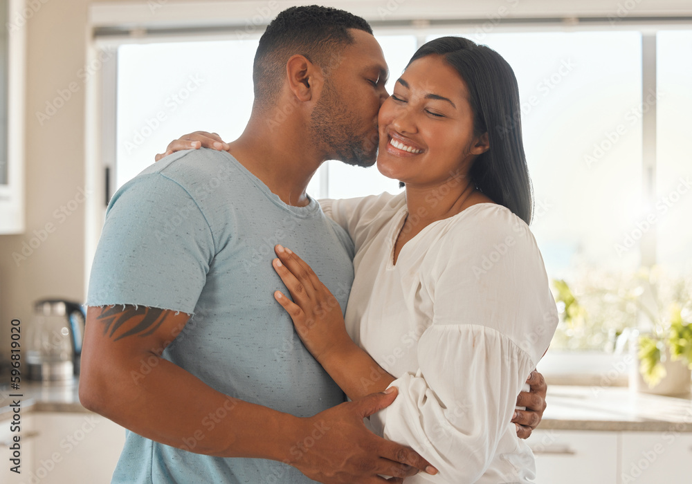 She deserves to be swept off her feet. Shot of an affectionate couple standing together in their home. She deserves to be swept off her feet. Shot of an affectionate couple standing together in their home.